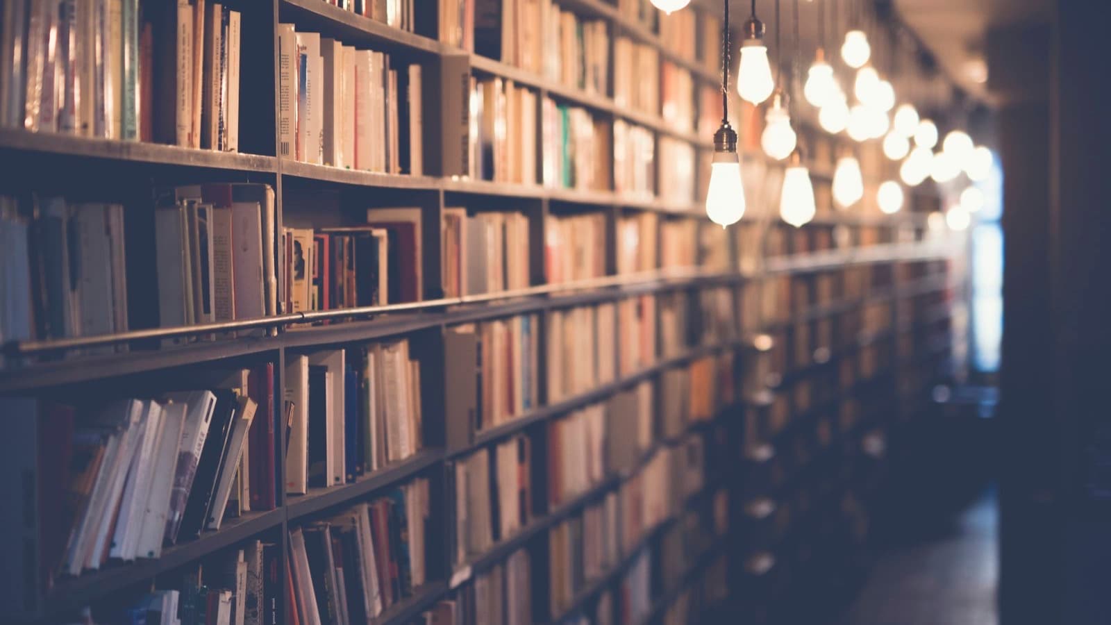 A large library with rows of lit bookshelves